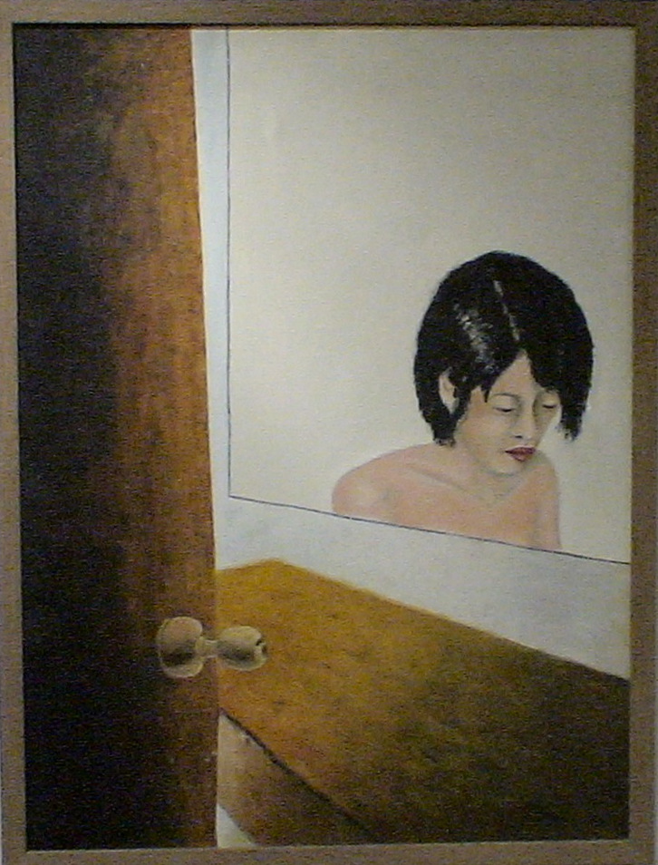 A seated bare shouldered woman seen in a mirror through a partially open door.