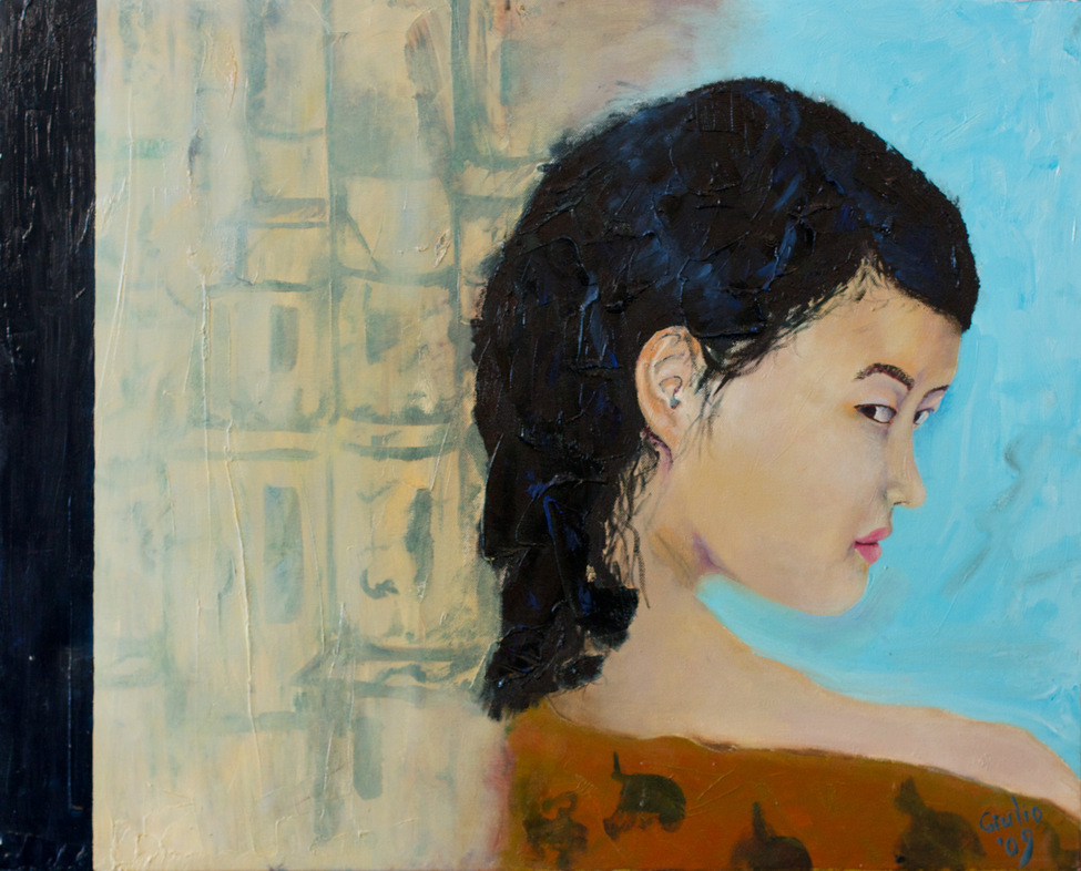 Girl looking back over her shoulder at viewer beside a curtain/wall