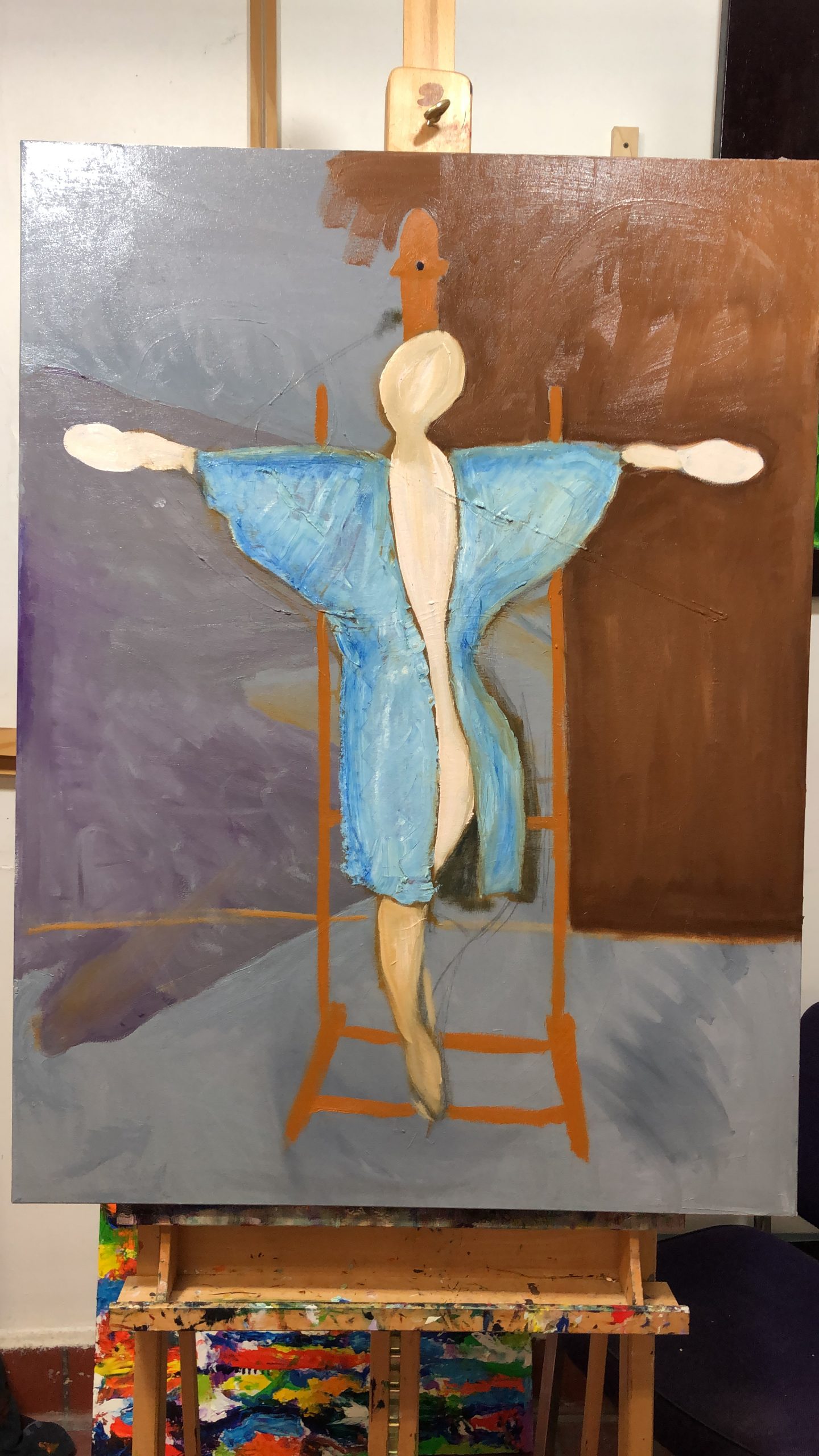 Half formed woman stepping down off an artist's easel